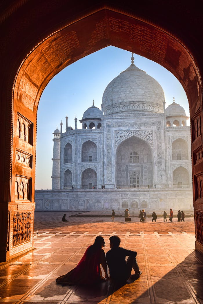 A couple sitting in front of the taj mahal